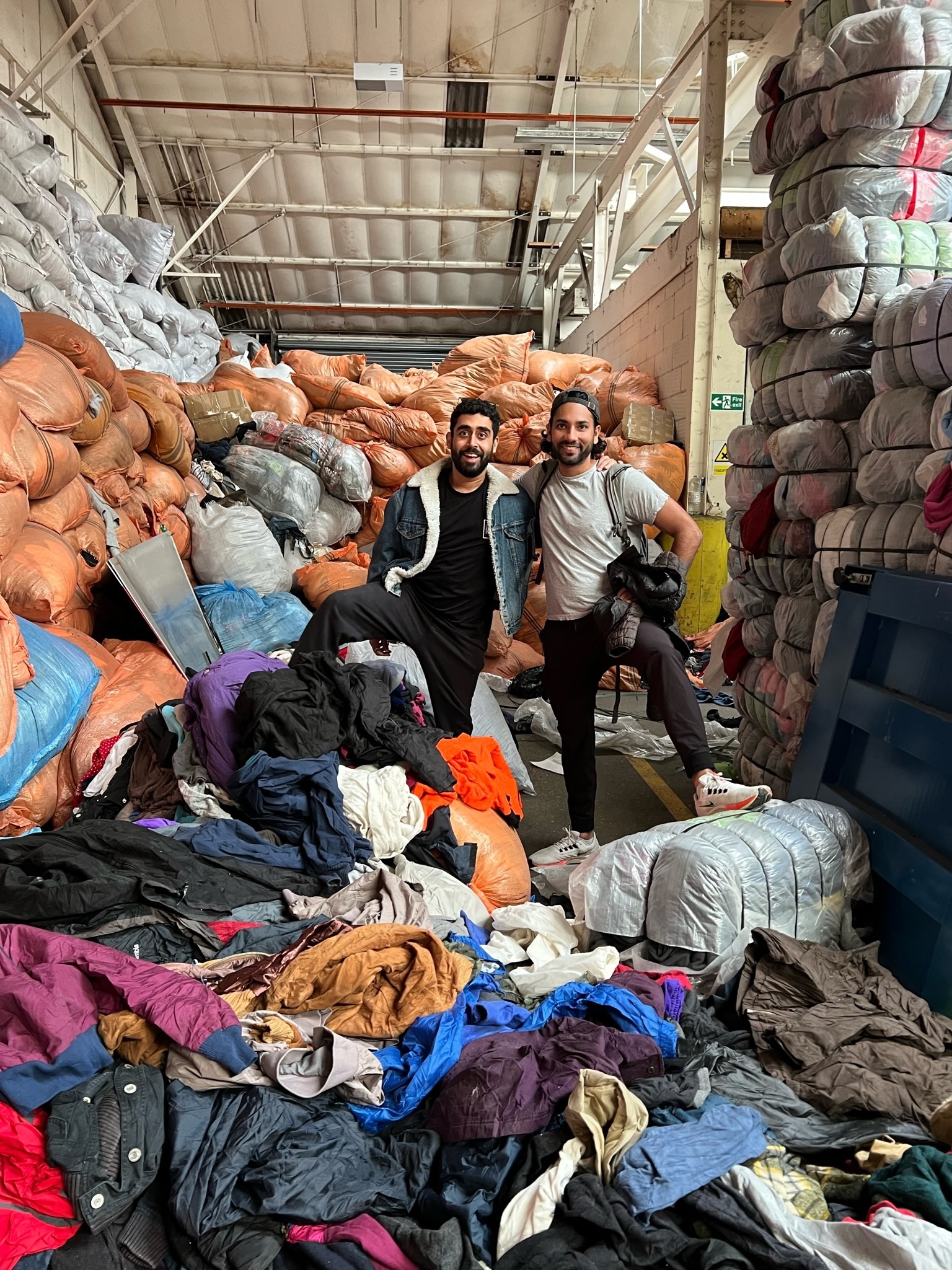 Abhi and Sanket in a secondhand clothing warehouse