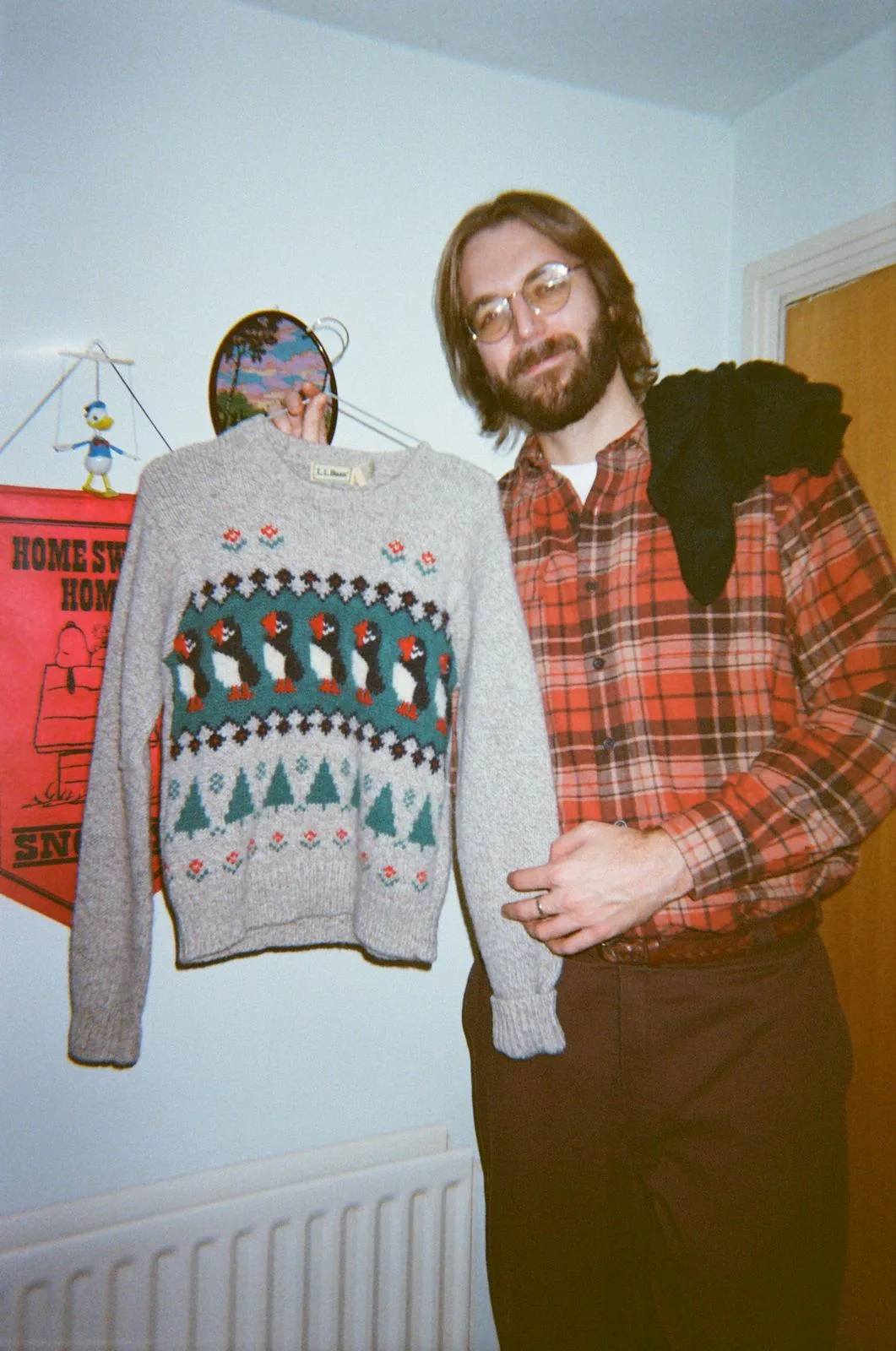 A reseller holding up a patterned Christmas jumper